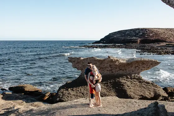Family photo session at Abades beach in Tenerife with volcanic rock formations