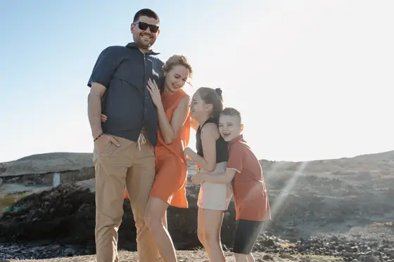 Lifestyle session in Tenerife - family posing by volcanic rocks in Abades