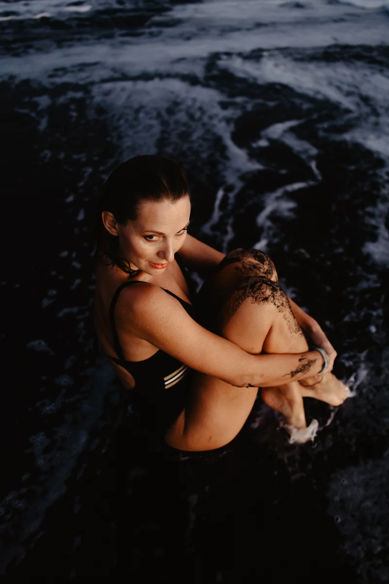 Joanna Moro delicate portrait session with ocean waves backdrop in Tenerife coastal setting