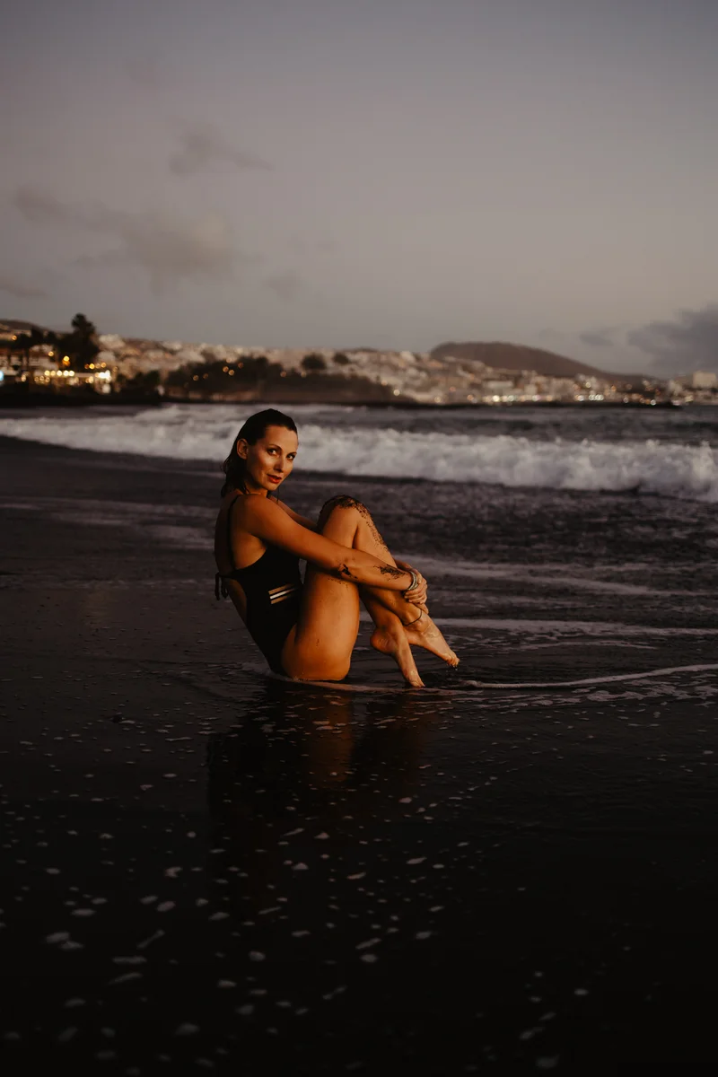 Joanna Moro feminine session lying on wet sand with silhouette reflection