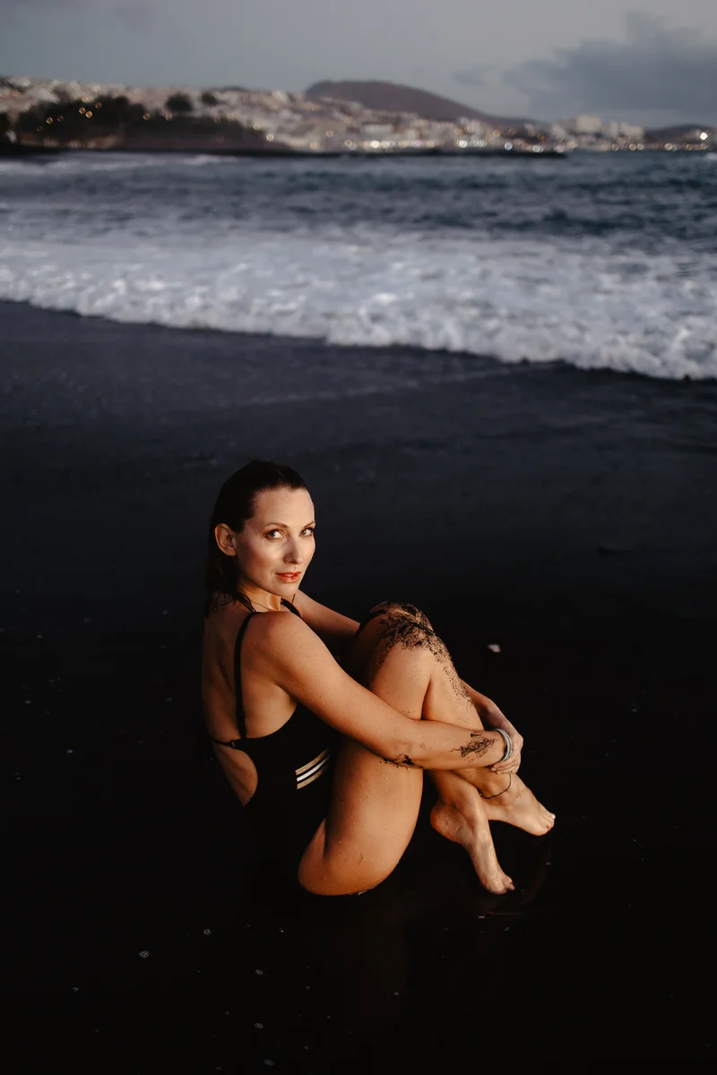 Joanna Moro portrait session on black volcanic beach in Tenerife with ocean waves