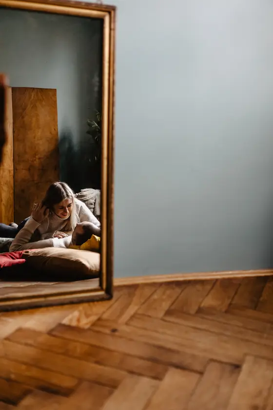 Woman preparing in bedroom mirror reflection before photo session preparation Tenerife
