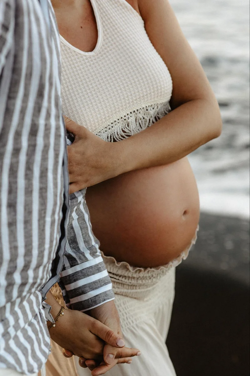Subtle maternity portrait in white styling during a Tenerife session