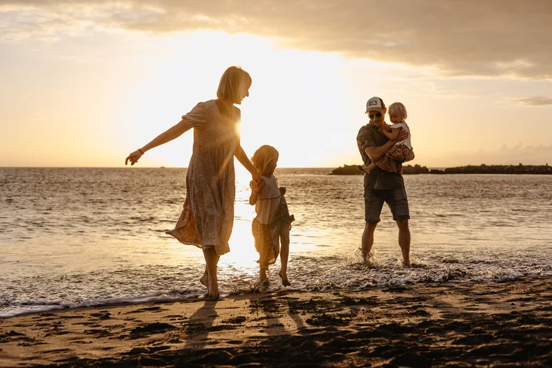 Family walking on a Tenerife beach during a natural sunset photo session