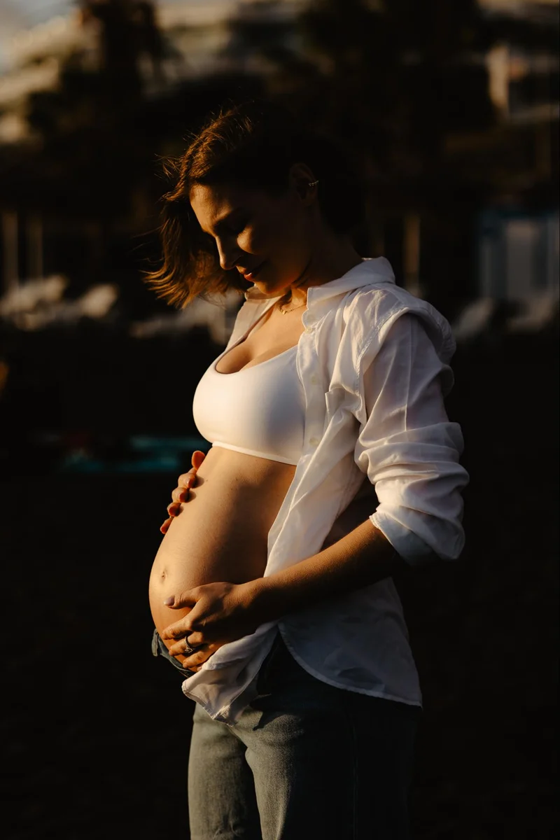 Pregnant woman in soft light during a maternity session in Tenerife
