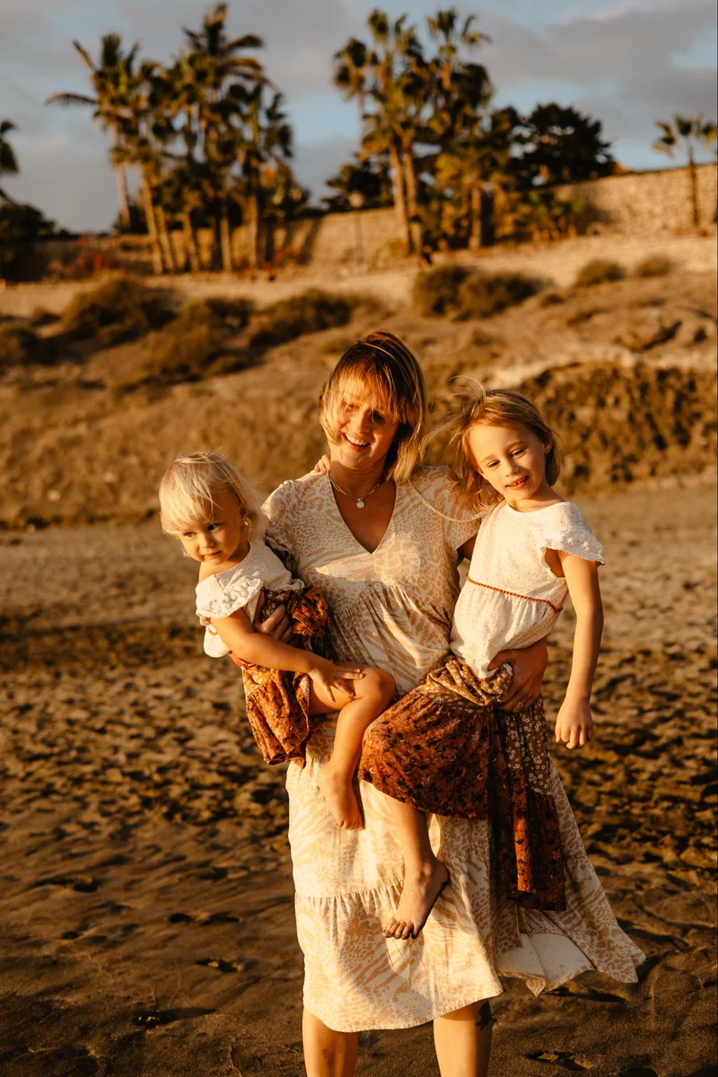 Mother with children sitting on the beach during a natural family session
