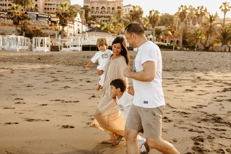 Family photo session on a wide beach in Tenerife