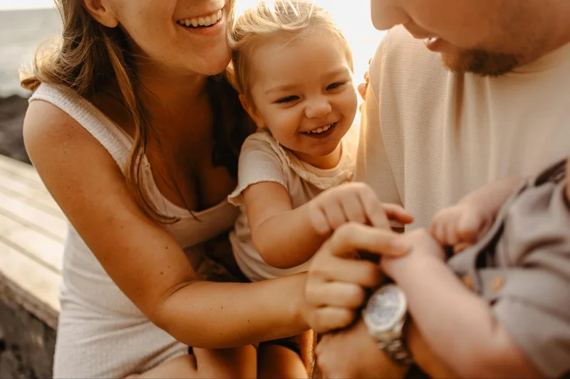 Family holding a baby during a tender photo session in Tenerife