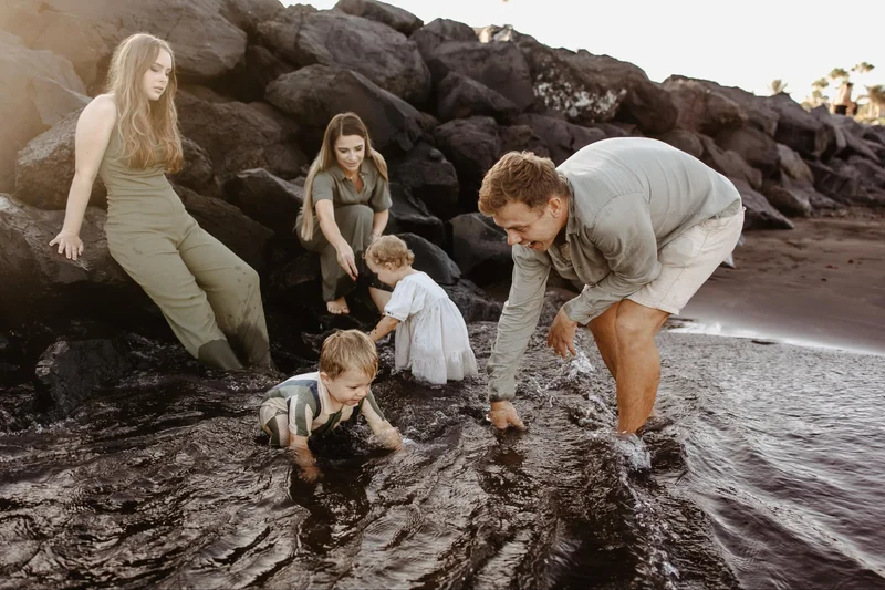 Family playing by the ocean during a lifestyle session in Tenerife