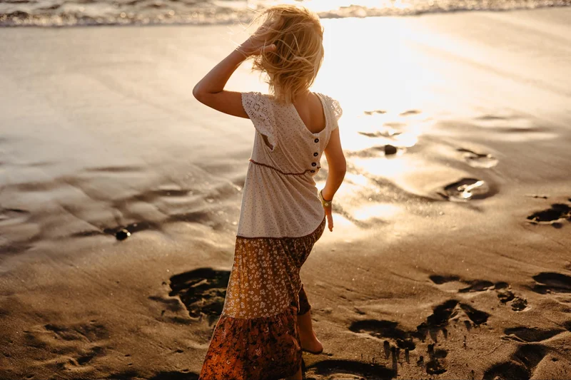 Couple dancing on the beach during a natural sunset photo session