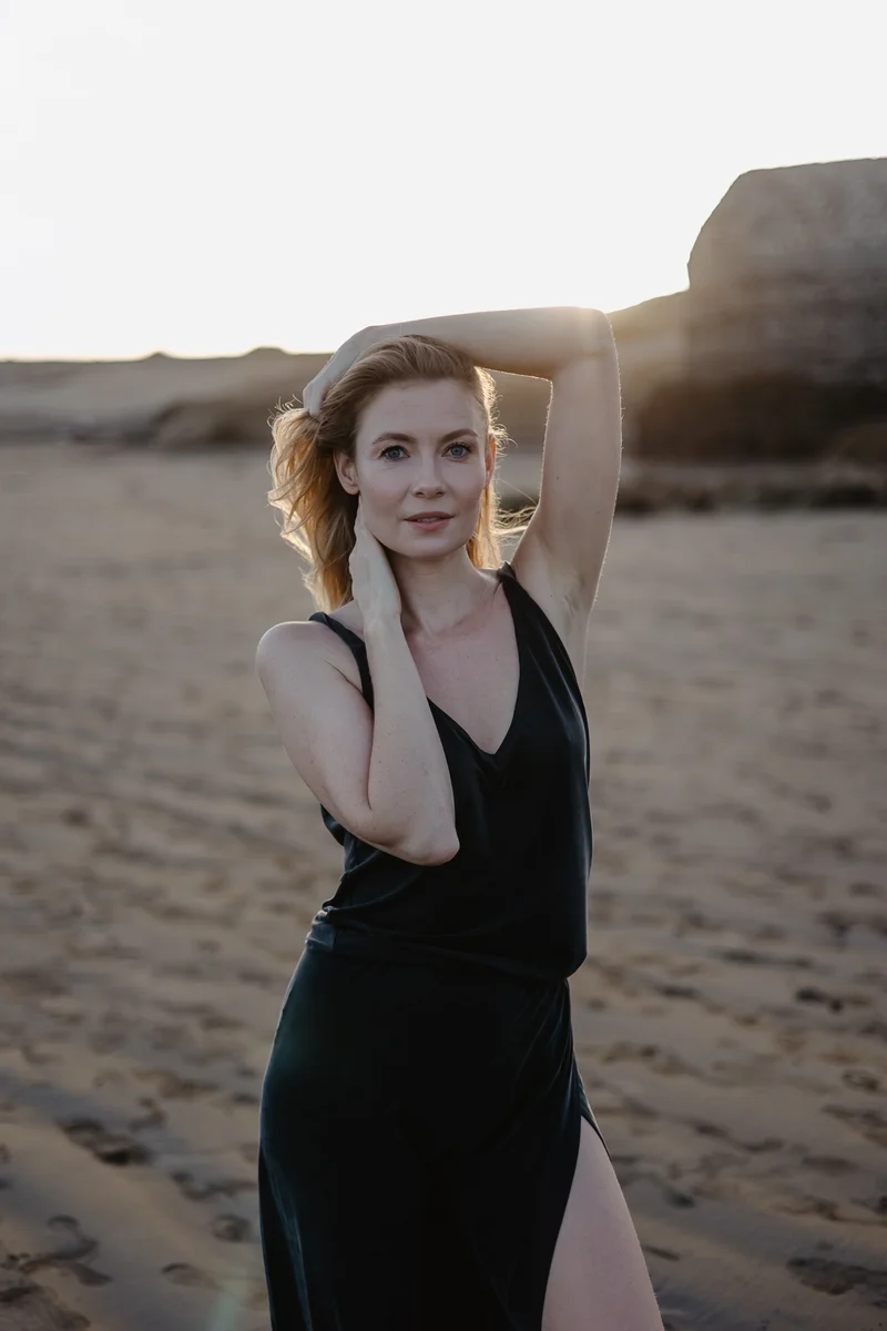 Karolina Chapko in elegant pose on sandy El Médano beach during golden hour with volcanic rocks