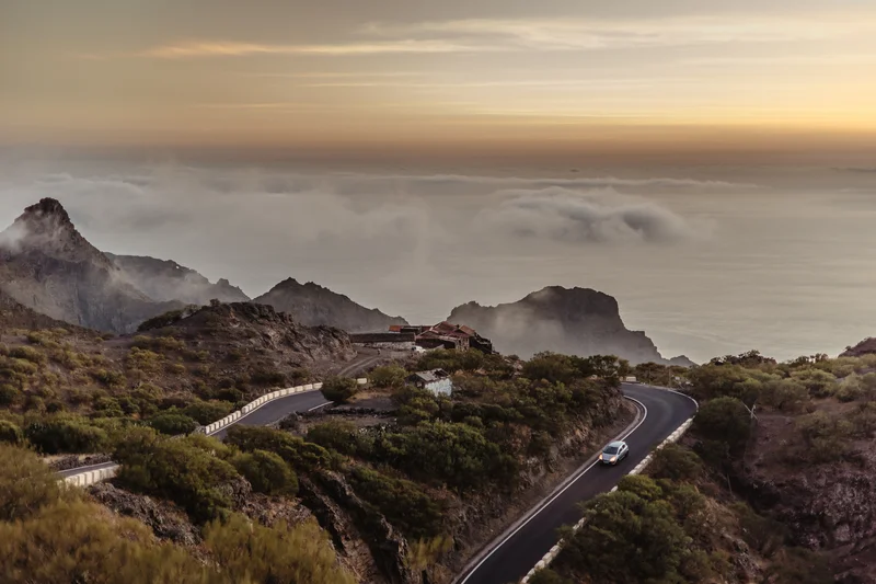 Masca wedding session serpentine mountain road through ravine with golden hour clouds