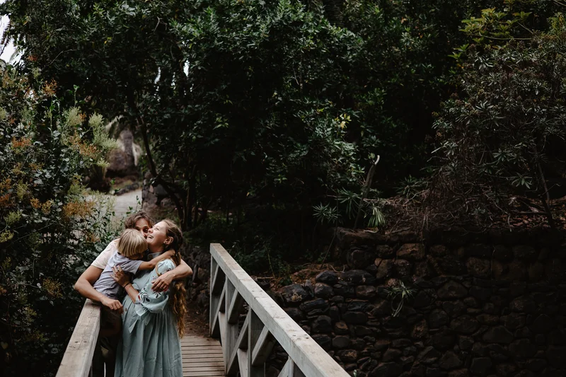 Expecting couple on wooden bridge during maternity photoshoot session in Tenerife
