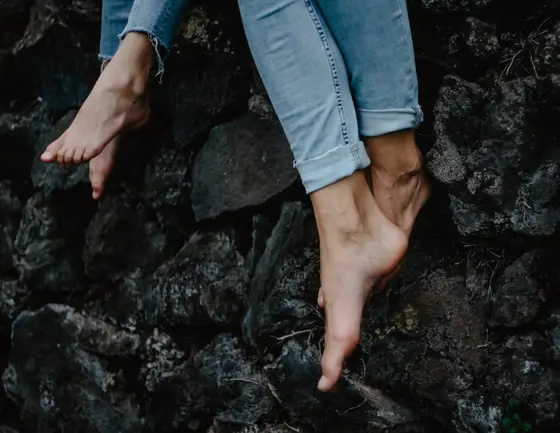 Artistic shot of feet on black volcanic rocks during Tenerife lifestyle photography session
