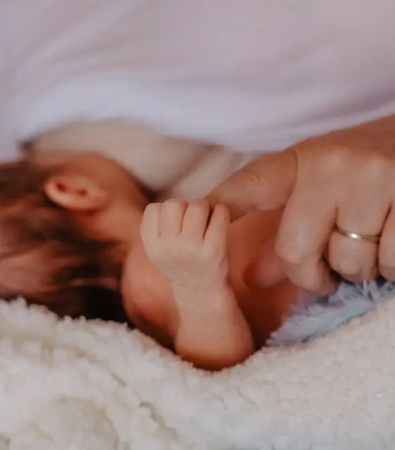 Newborn holding parent's hand showing bond during newborn photography Tenerife session