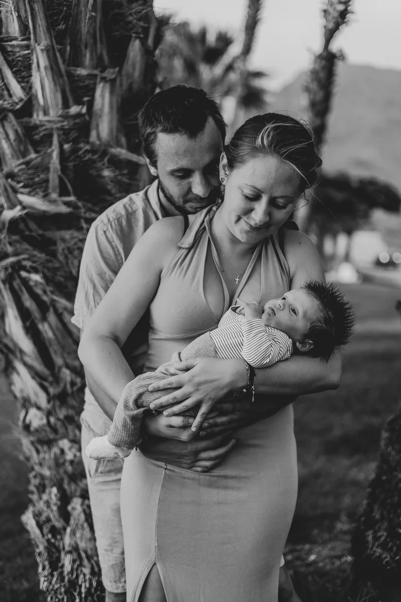 Black and white portrait of parents with newborn during artistic outdoor newborn photography session Tenerife
