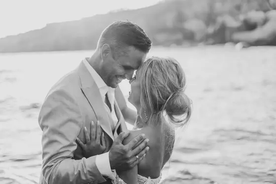 Black and white intimate moment of wedding couple touching foreheads on Playa Paraiso beach