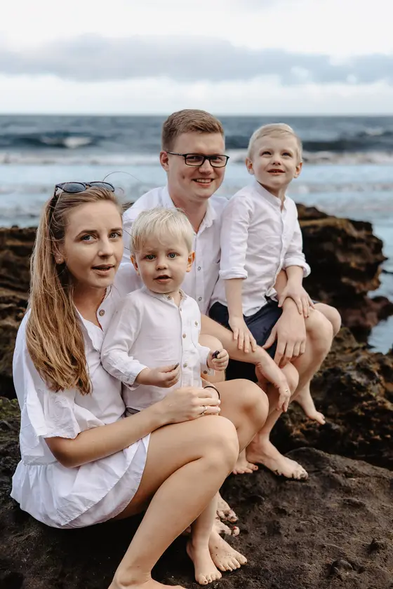 Joyful family portrait on Tenerife volcanic rocks with smiling parents and children
