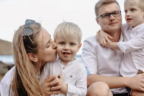 Tender moment between mother and son during family session on Tenerife volcanic rocks