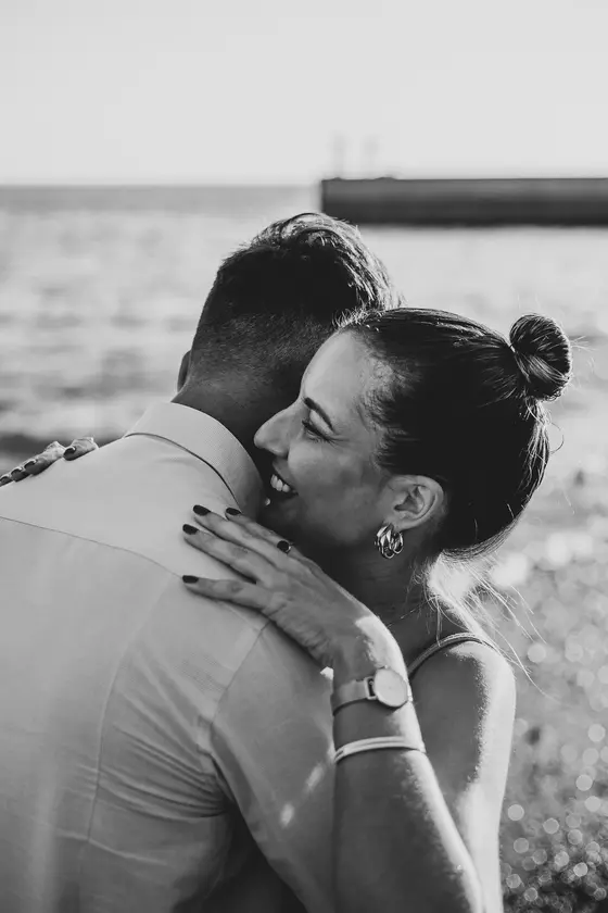 Intimate black and white portrait of Spanish couple by ocean in Tenerife