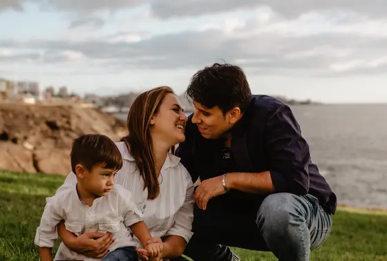 Intimate family moment with child overlooking ocean during family photography Tenerife coastal session