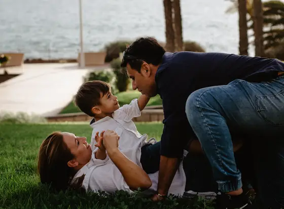 Mother playing with child on grass during family photography Tenerife outdoor session