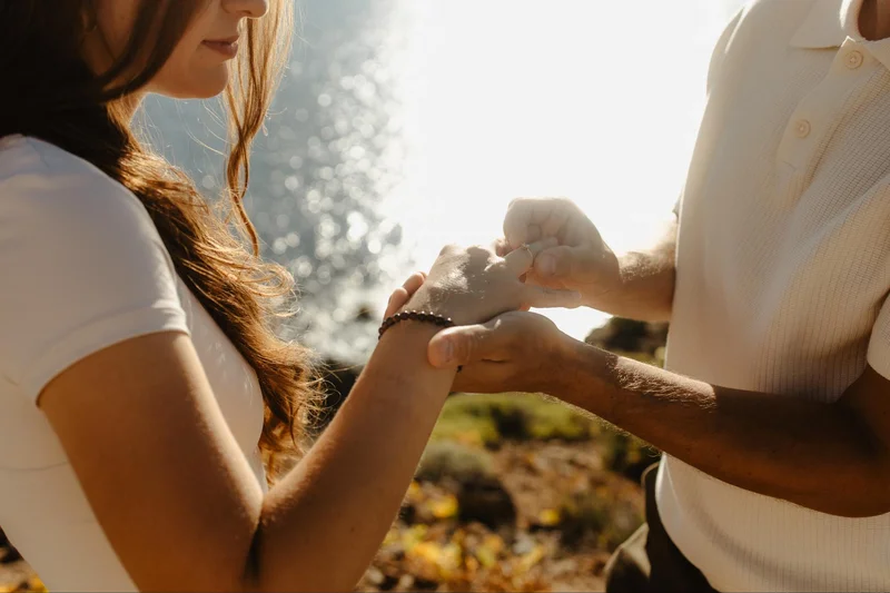 Manos y anillo de compromiso durante una sesión de pedida