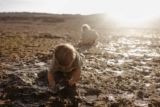 Children playing on volcanic beach during family vacation Tenerife session joyful holiday memories