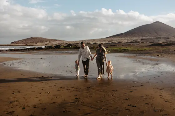 Family holding hands beach Tenerife family session vacation unity love mountain