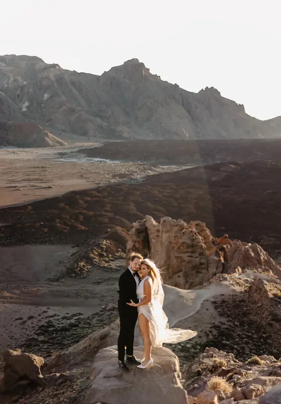 Tenerife wedding session couple on volcanic cliffs dramatic landscape Atlantic ocean view